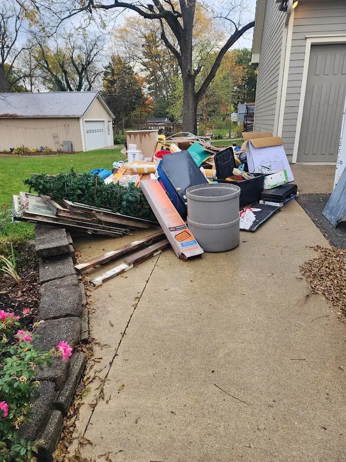 Dumpster being loaded with debris for 3 Yard Dumpster Rental in Falmouth